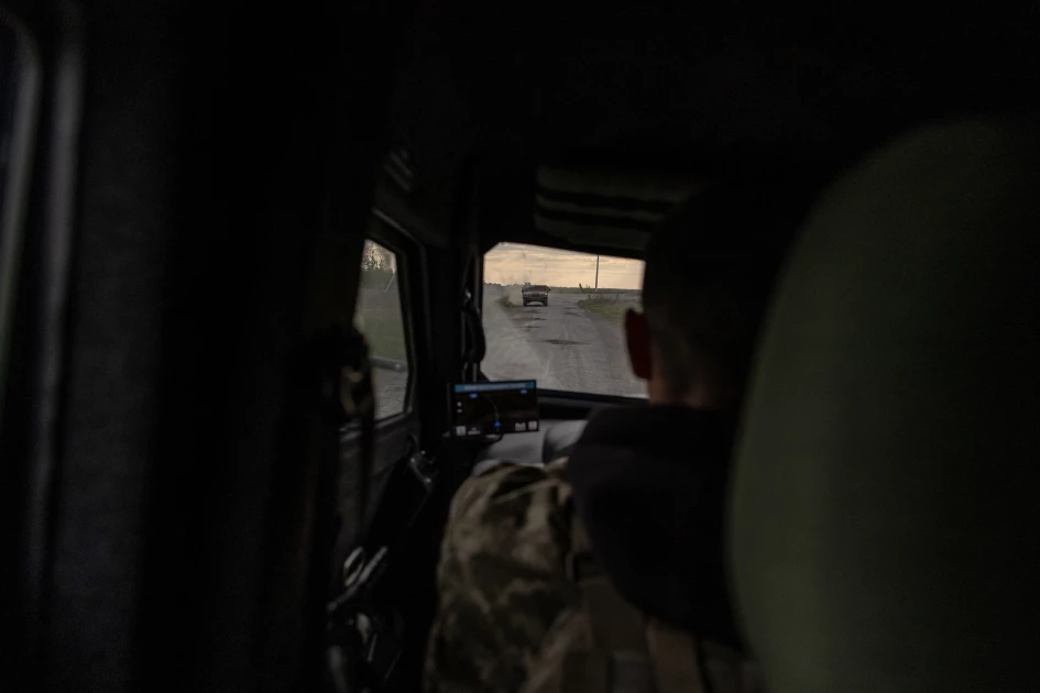 Ukrainian military members ride in a US-made Humvee on a road in the Kharkiv region, on May 16, 2024, amid the Russian invasion of Ukraine. (Photo by Roman PILIPEY / AFP)