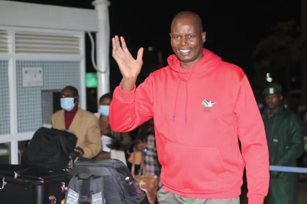 Malkia Strikers head coach Paul Bitok waves at JKIA moments before leaving for a High Performance Training camp in Brazil on Sunday 26, 2022.