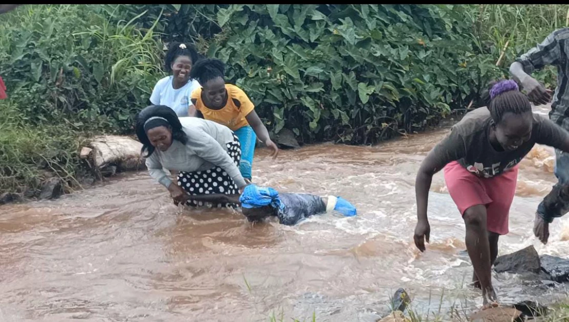 Kibukure residents in Mwea, Kirinyaga County, cross the Kiwe River on May 14, 2024, after its bridge was swept away by water. | PHOTO: Johnson Muriithi/Citizen Digital Some children from Kibukure village in M